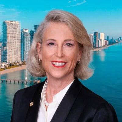 Dana Goldman, smiling, with the Sunny Isles Beach skyline behind her